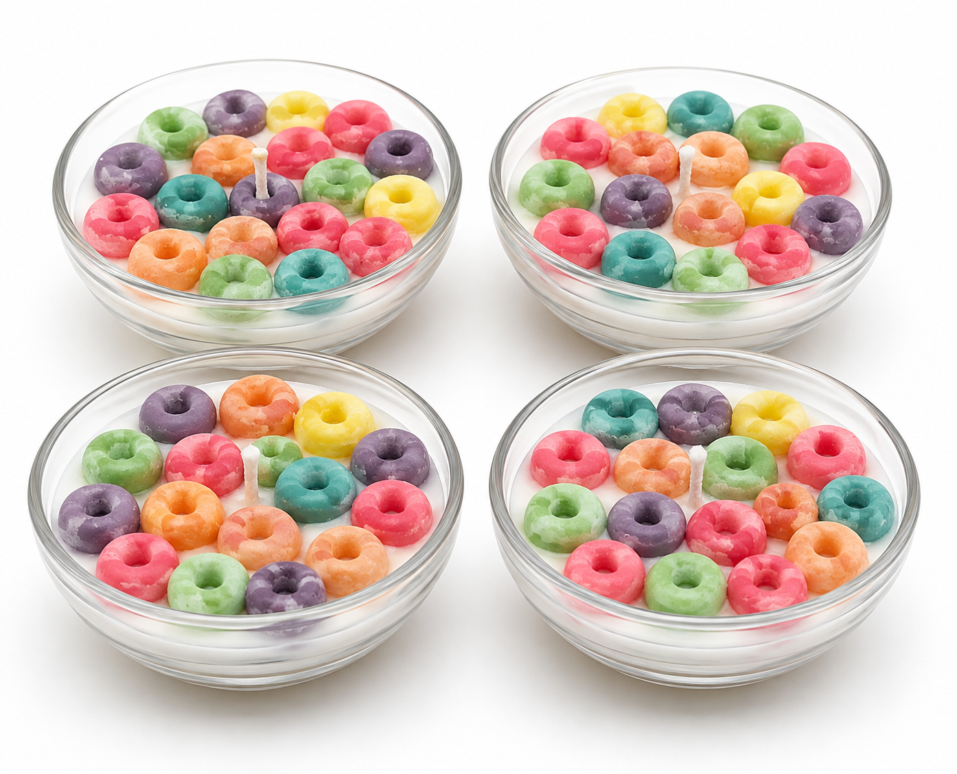 Four clear glass bowls filled with colorful ring-shaped candies arranged in a 2x2 grid on a white background.