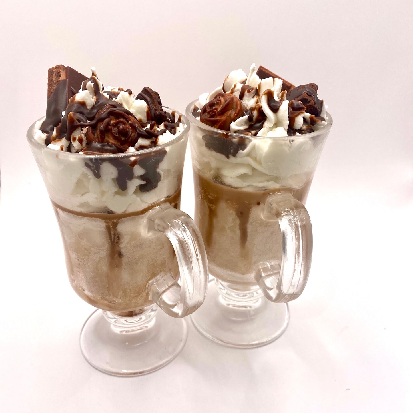 Chocolate sundae candle with wick lit, showcasing warm glow in glass container