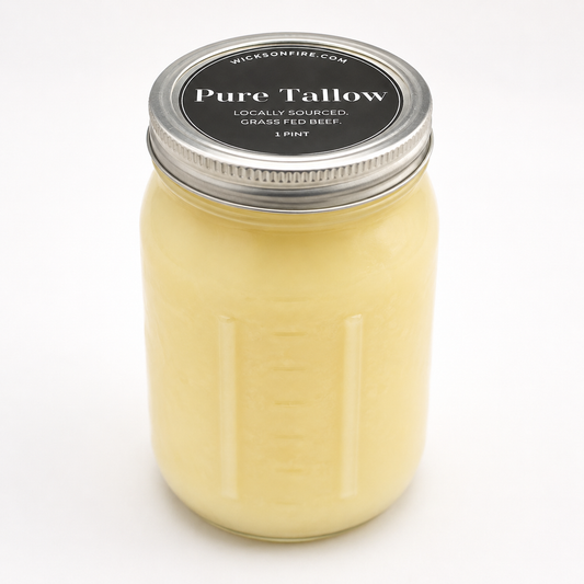 A 1 pint glass jar candle with a silver metal lid and a black label reading 'Pure Tallow' by Wickson Fire, filled with pale yellow wax, shown on a white background.