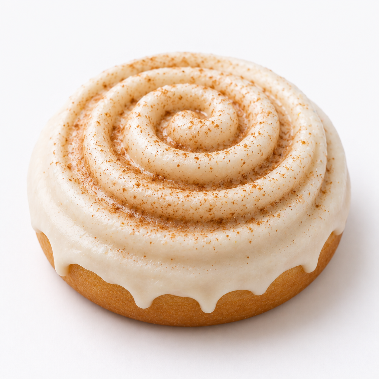 A single cinnamon roll with creamy white frosting and a dusting of cinnamon powder, photographed on a clean white background.
