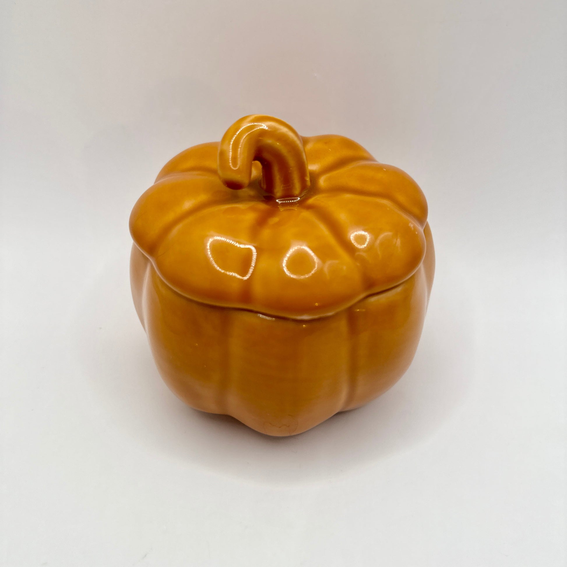 Ceramic pumpkin-shaped candle