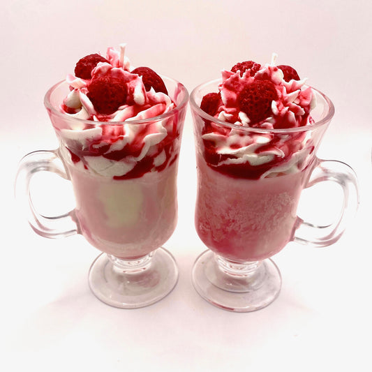 Detailed shot of strawberry scented soy wax candle with vibrant pink hues and wax fruit on top